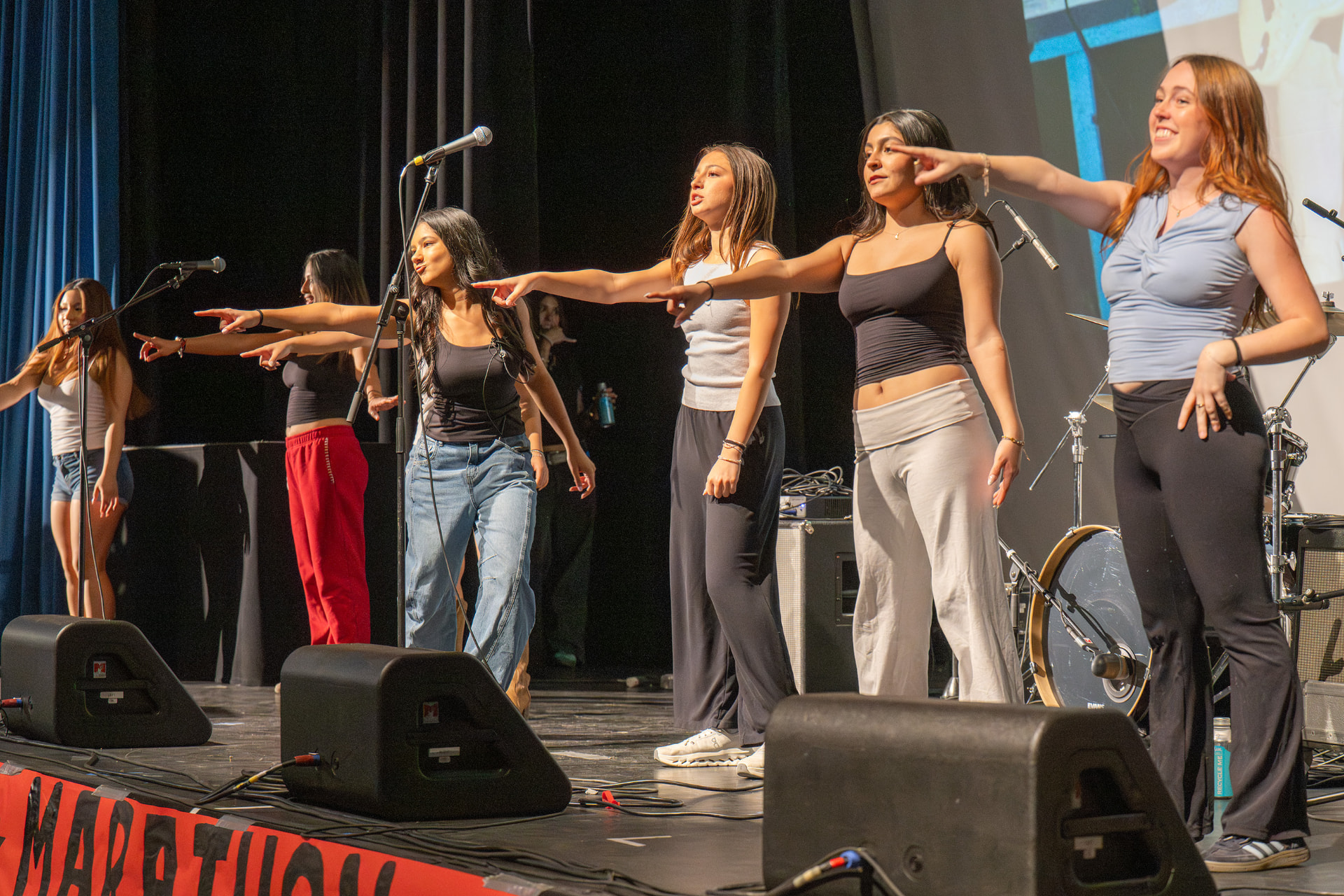 Student performers dancing on stage at a dance marathon