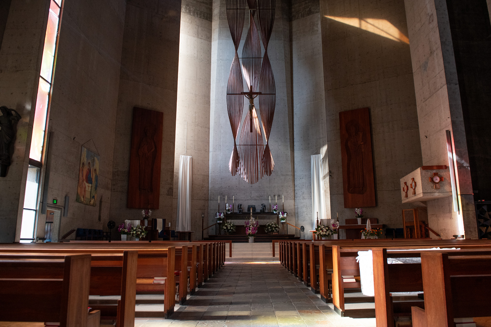 Modern concrete sanctuary with hanging sculpture