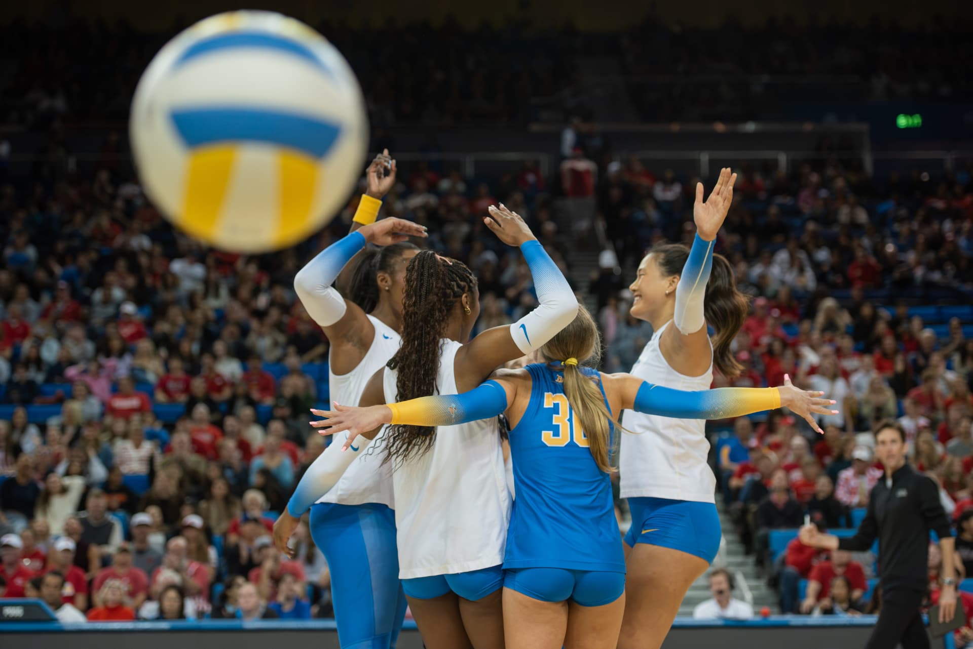 UCLA volleyball team celebrating a point