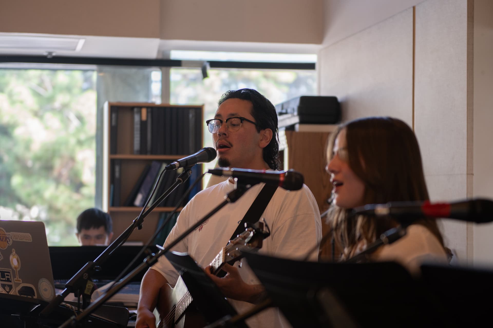 Musicians singing and playing guitar during a campus service