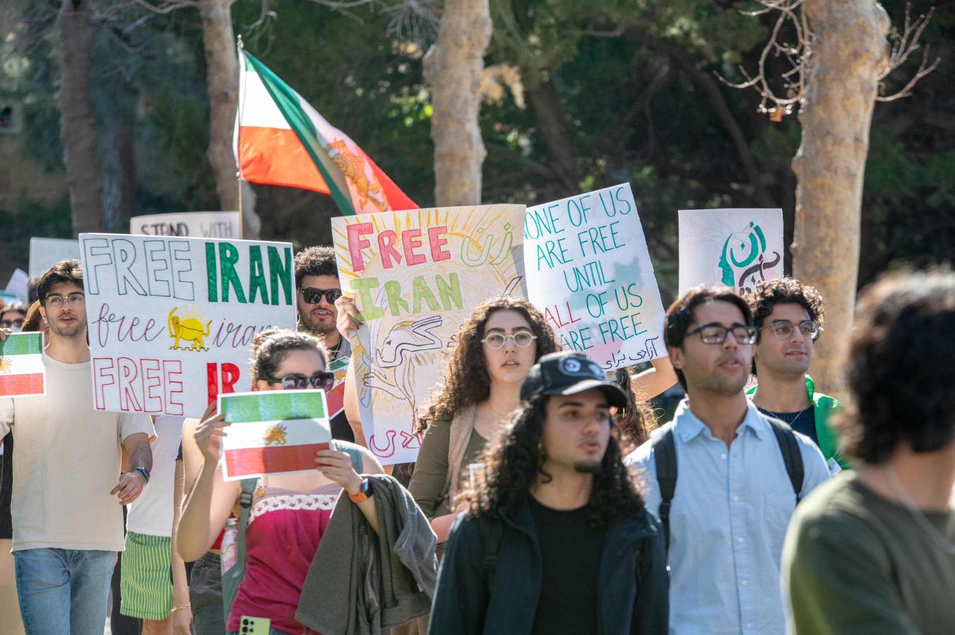 Protesters holding Free Iran signs on campus
