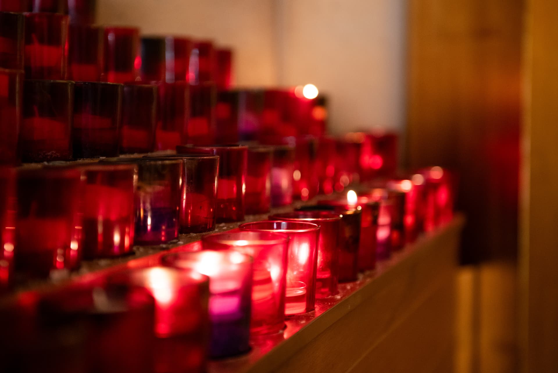 Rows of red votive candles