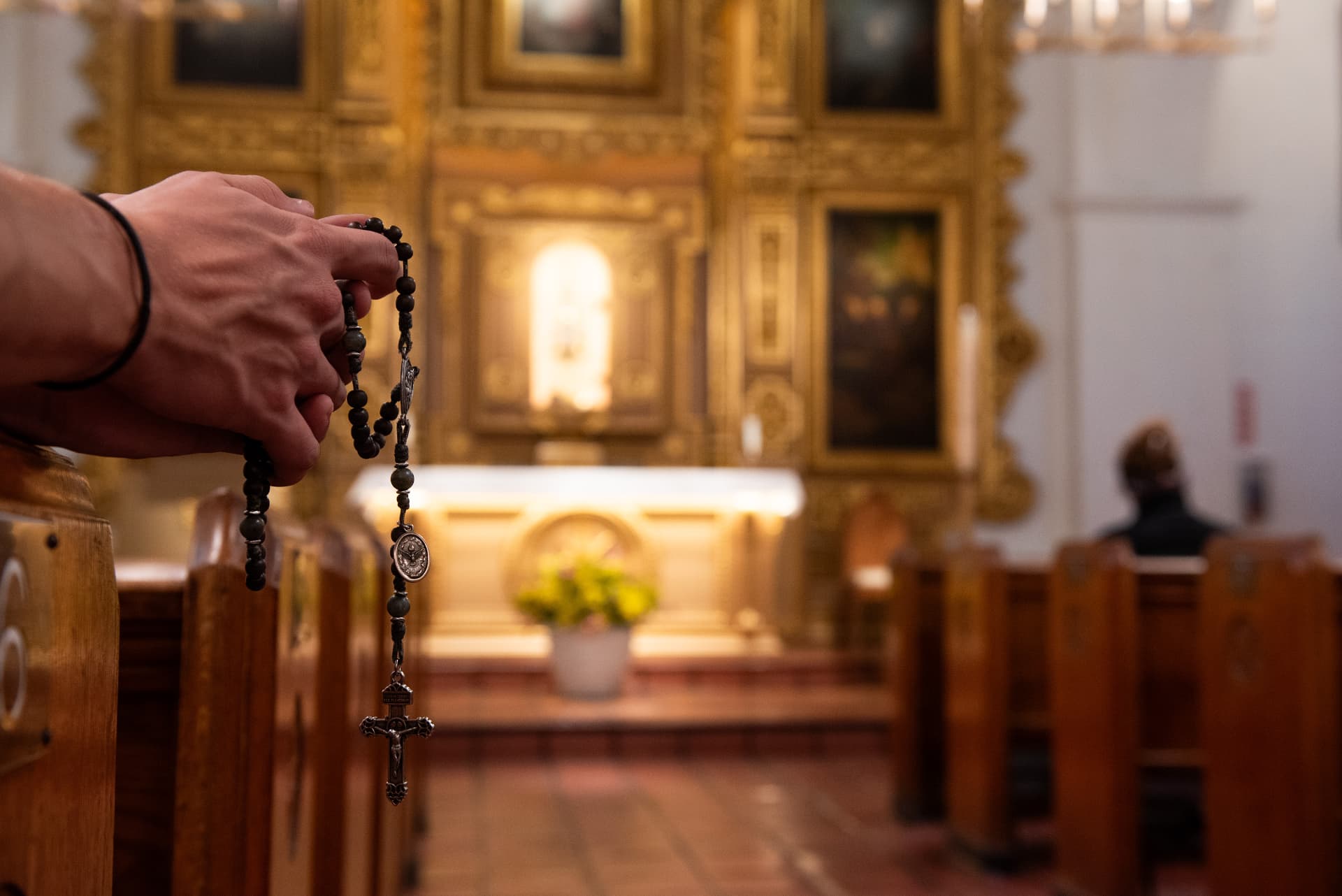 Rosary held in a church pew