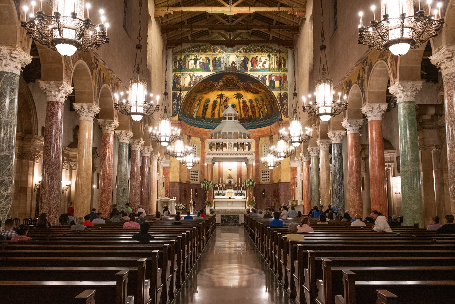 Ornate basilica nave with chandeliers