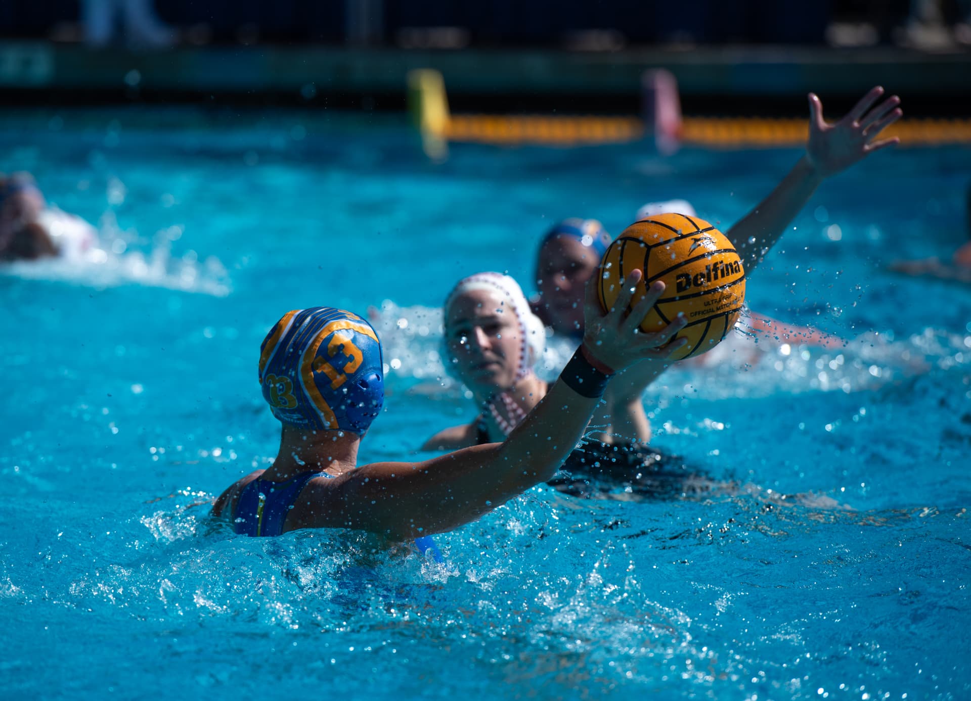 Water polo players battling for possession