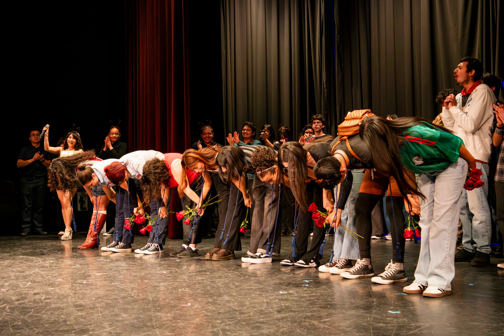 Cast taking a bow with roses at curtain call