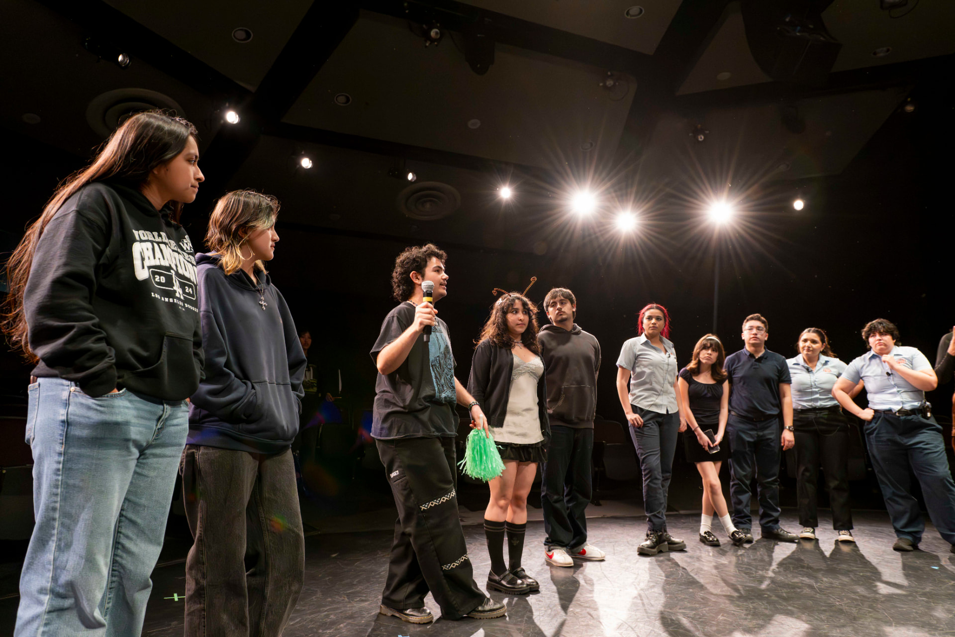 Cast lined up on stage during a curtain speech