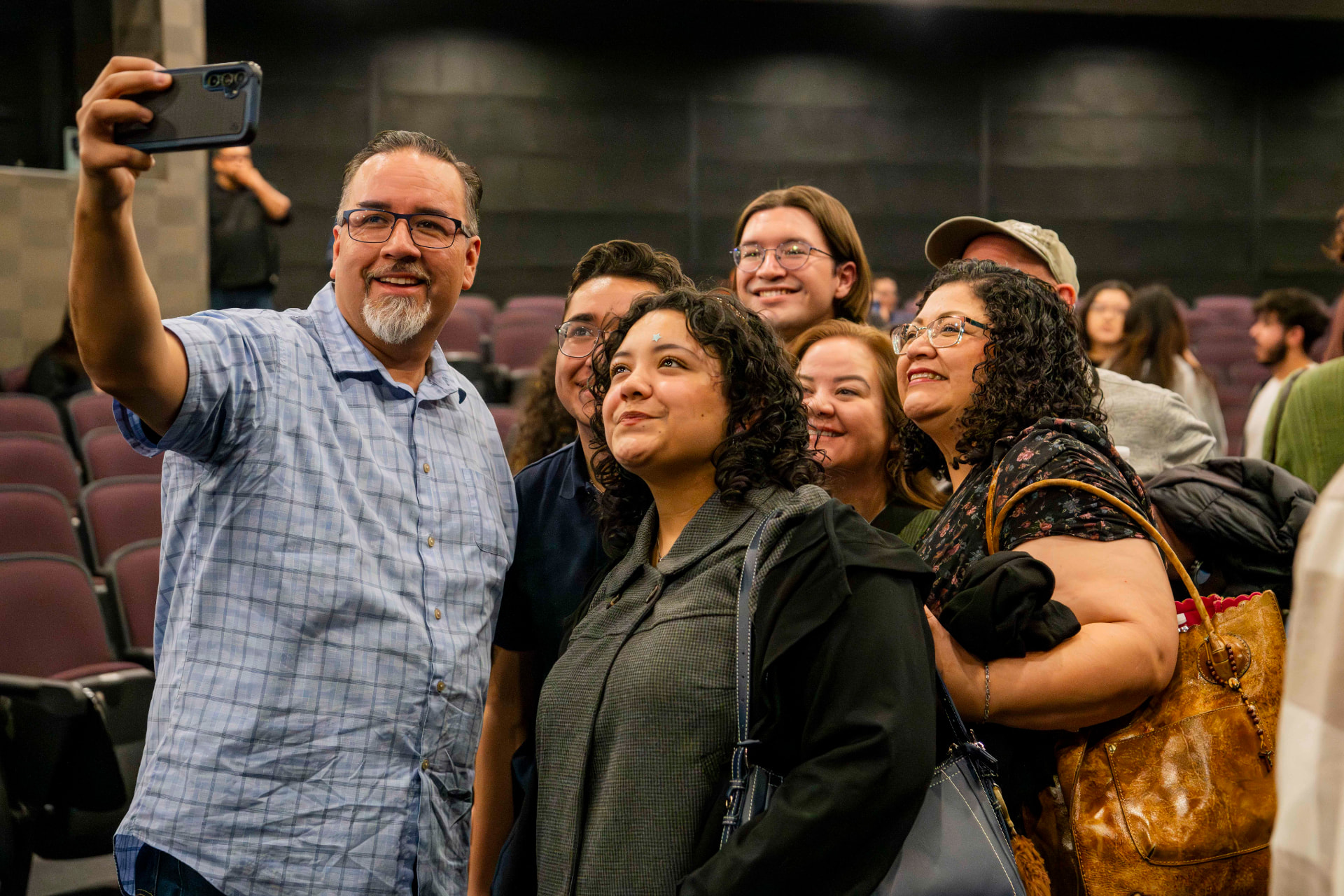 Audience members taking a group selfie after the show