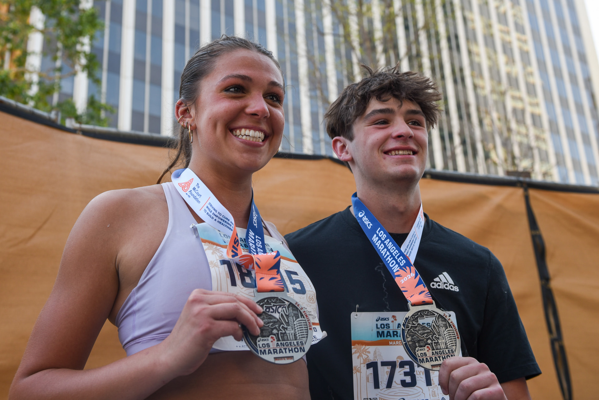 Two finishers posing with their LA Marathon medals